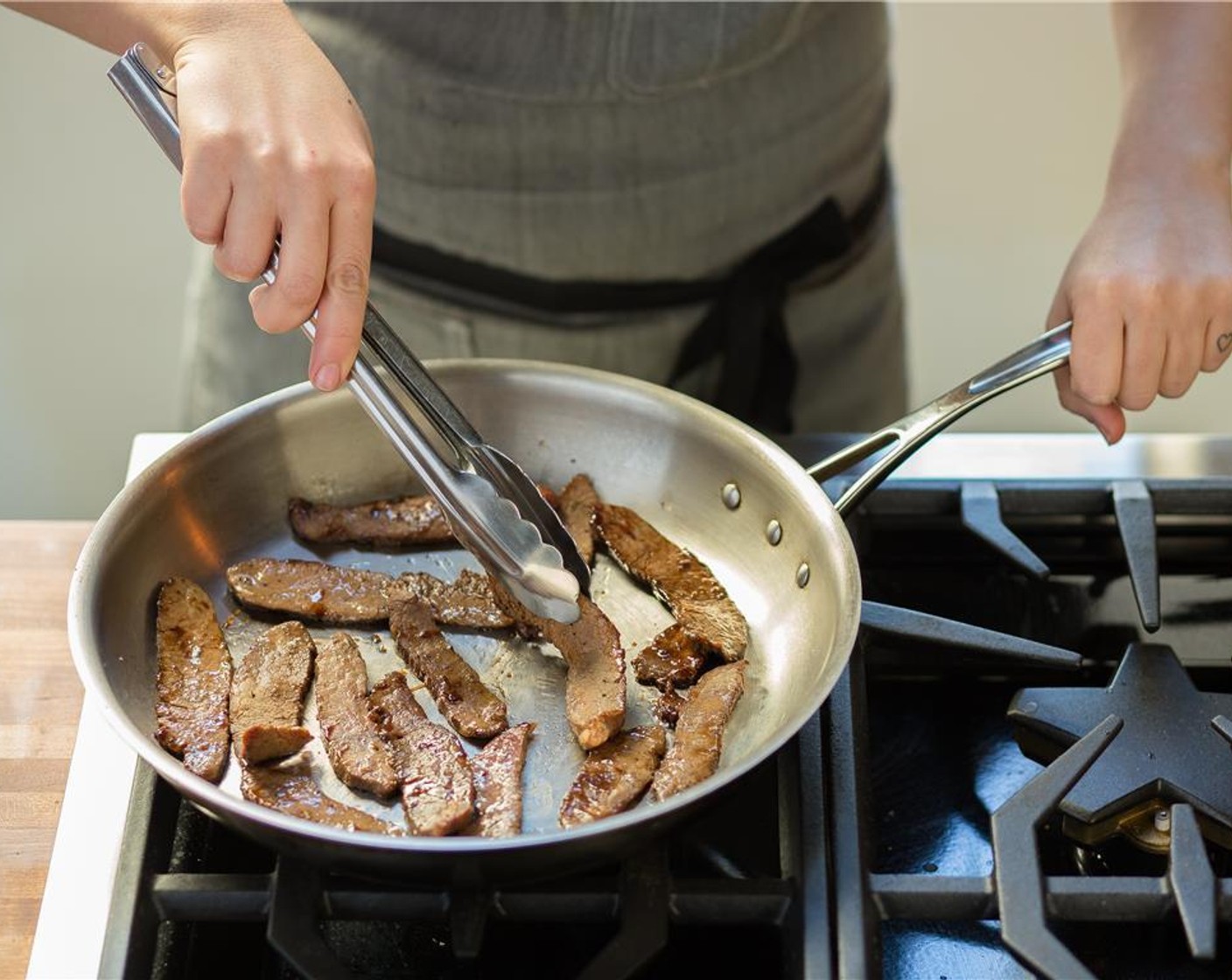 step 4 In a sauté pan over medium high heat, add Olive Oil (1 Tbsp). When hot, add flank steak in a single layer and cook for 1 minute on each side. Transfer to a plate.