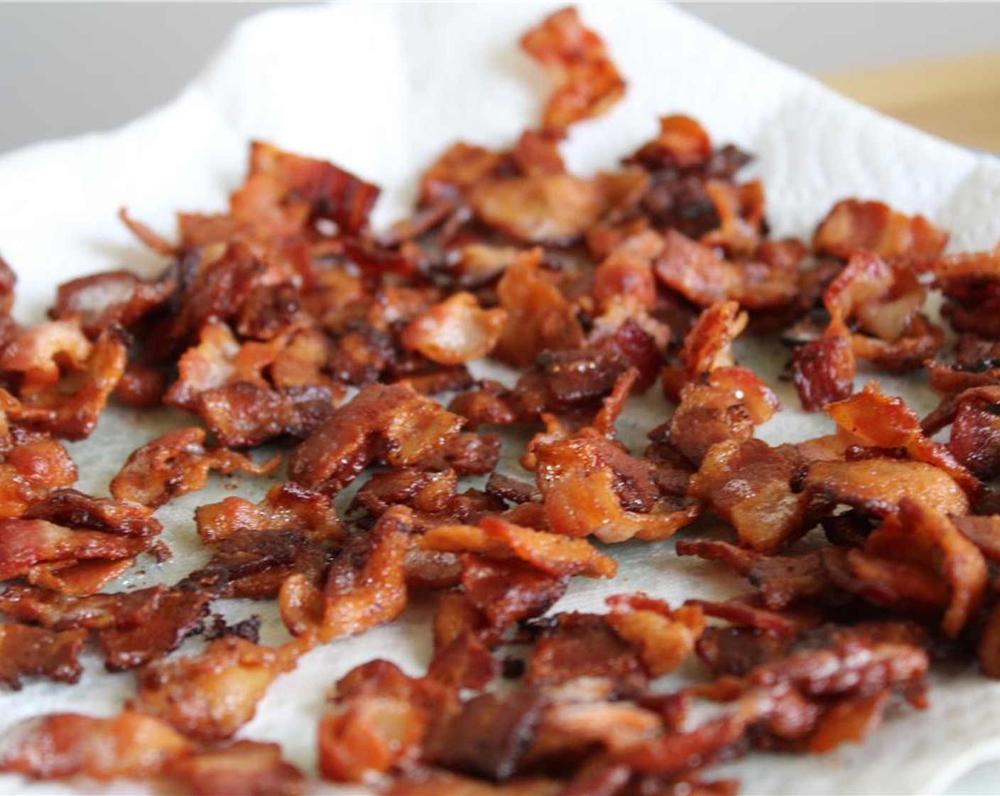step 7 In a large skillet over medium heat, fry the chopped bacon until crispy. Drain on a paper towel-lined plate and reserve the rendered bacon grease.