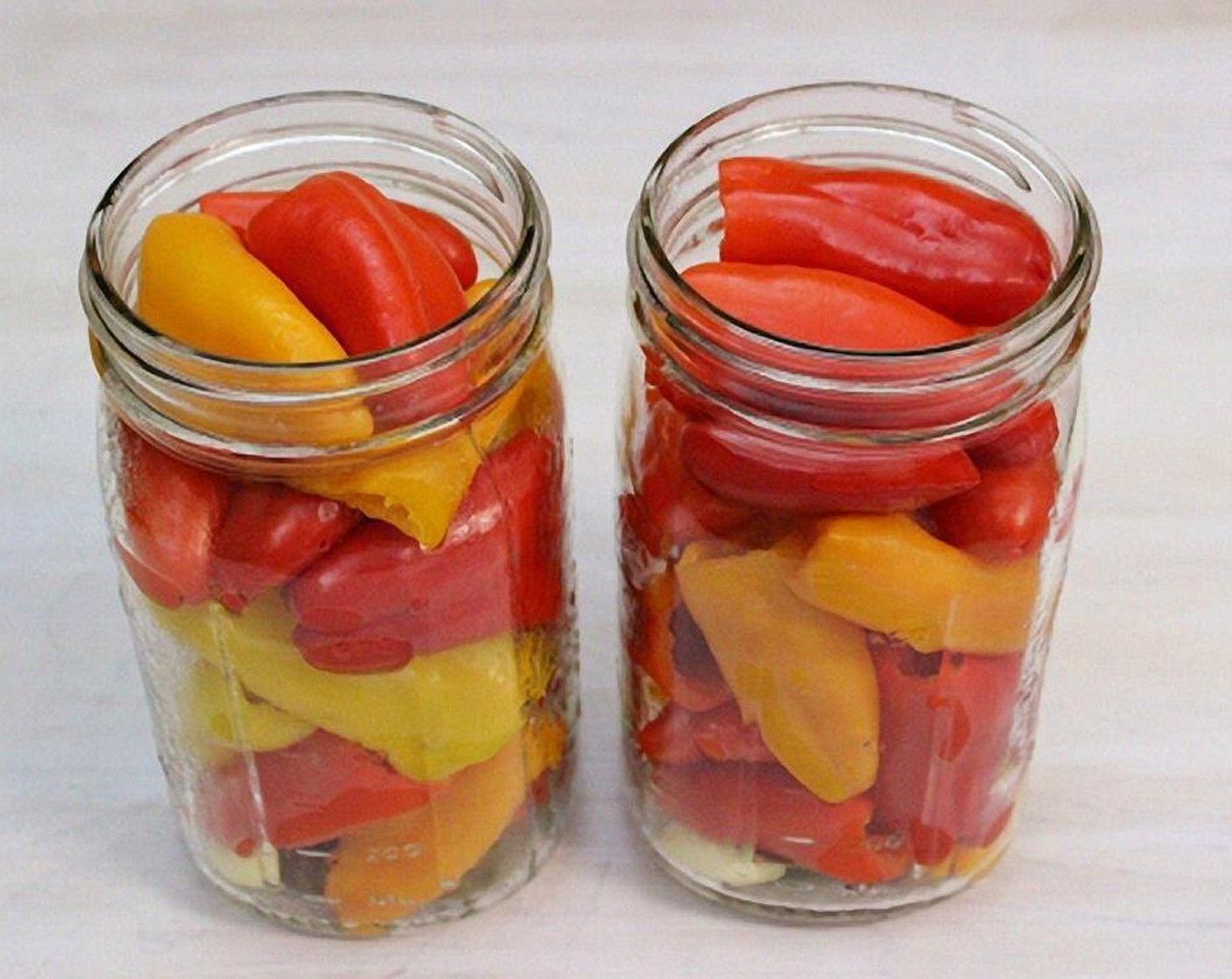 step 4 Add the peppers to each jar.