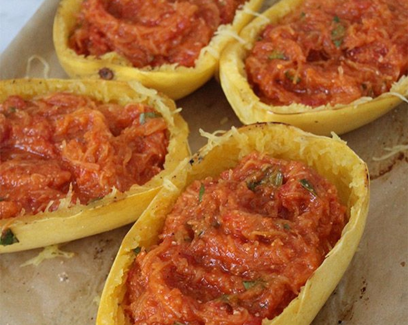 step 8 Transfer the squash to a large mixing bowl, and add the Marinara Sauce (1 jar), Parmesan Cheese (1/4 cup), Fresh Basil Leaf (1/3 cup), Kosher Salt (1 tsp), and Freshly Ground Black Pepper (1/2 tsp). Mix thoroughly, then divide the mixture between the reserved squash shells.