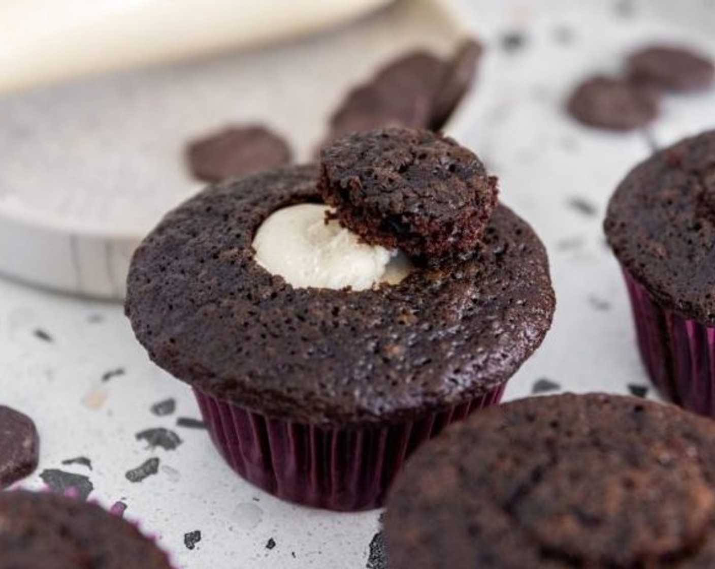 step 16 Use a large piping tip or a teaspoon to carve out the center of each cupcake. Fill each cupcake with the cardamom meringue and place the carved-out cake on top to cover the meringue.