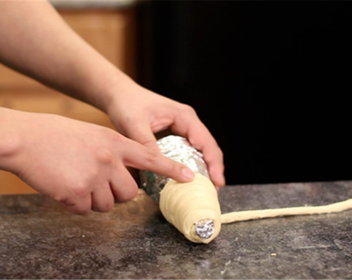 step 4 Roll the skinny dough around the foil cone.