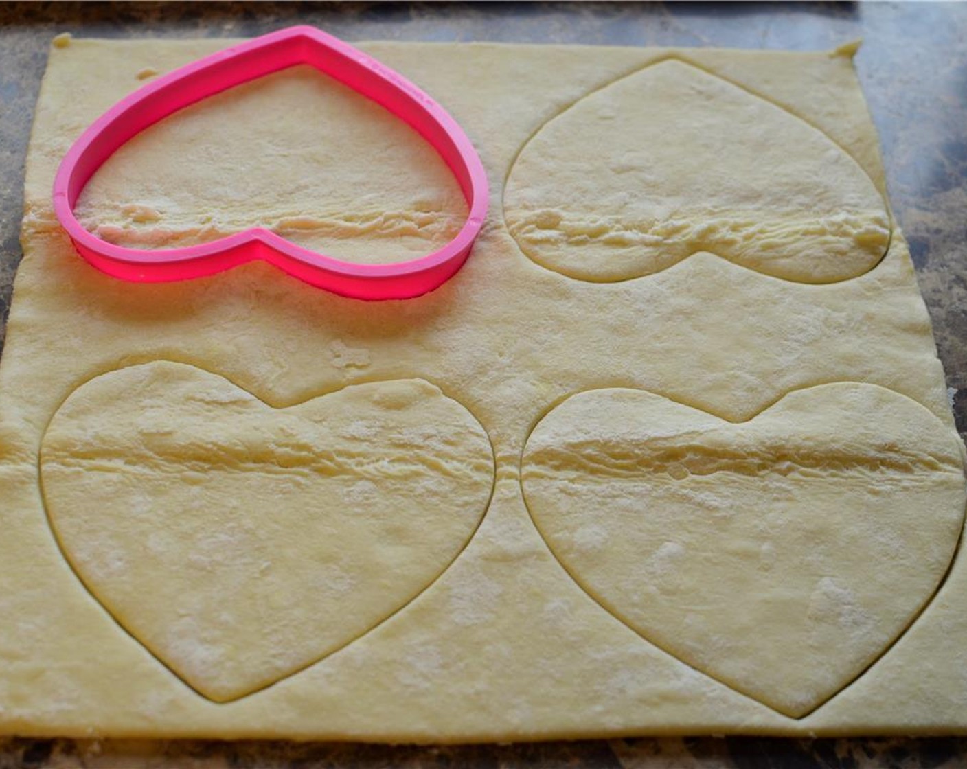 step 1 Unfold sheet of Puff Pastry (1) and using a heart shaped cookie cutter, cut out 4 hearts.