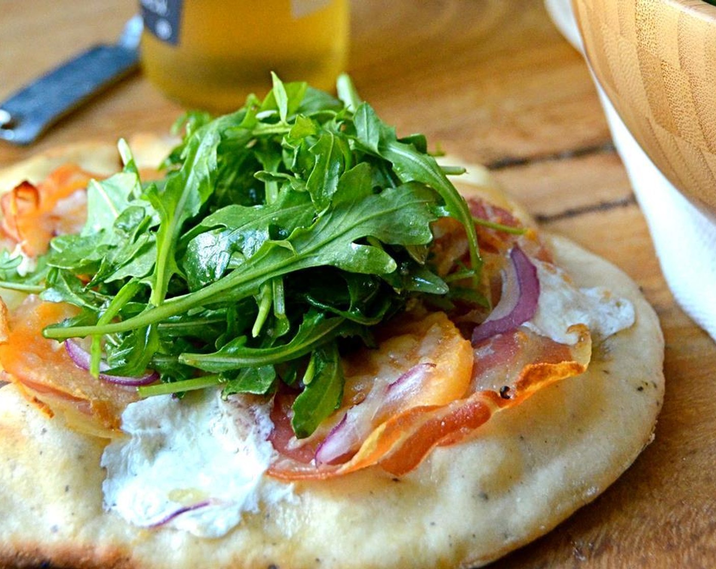 step 20 Add the dressing to the arugula and toss. Serve pizzas individually with a nest of arugula on top, or cut into wedges and top each wedge with greens. Enjoy!