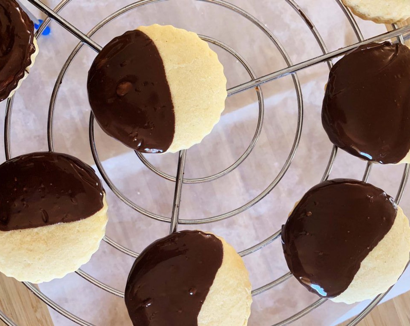 step 8 In a double saucepan, melt the Dark Chocolate (3 1/2 Tbsp), then dip half of each cookie into the melted chocolate. On some cookies, you add Desiccated Coconut (to taste) as desired. Let them cool on a wire rack.