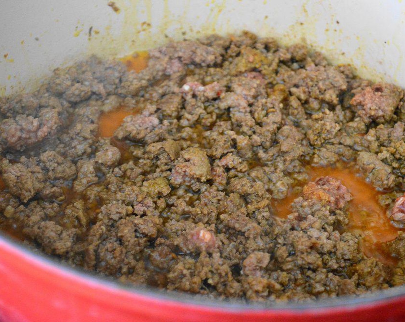 step 1 Heat the Olive Oil (2 Tbsp) in a large Dutch oven over medium high heat. Brown the Ground Beef (1 lb) in it completely while you break it up with a spoon. While the beef cooks season it with the Salt (1/2 tsp), Crushed Red Pepper Flakes (1/2 tsp), Ground Turmeric (1/2 tsp), Ground Coriander (1/2 tsp), and Smoked Paprika (1/2 tsp).