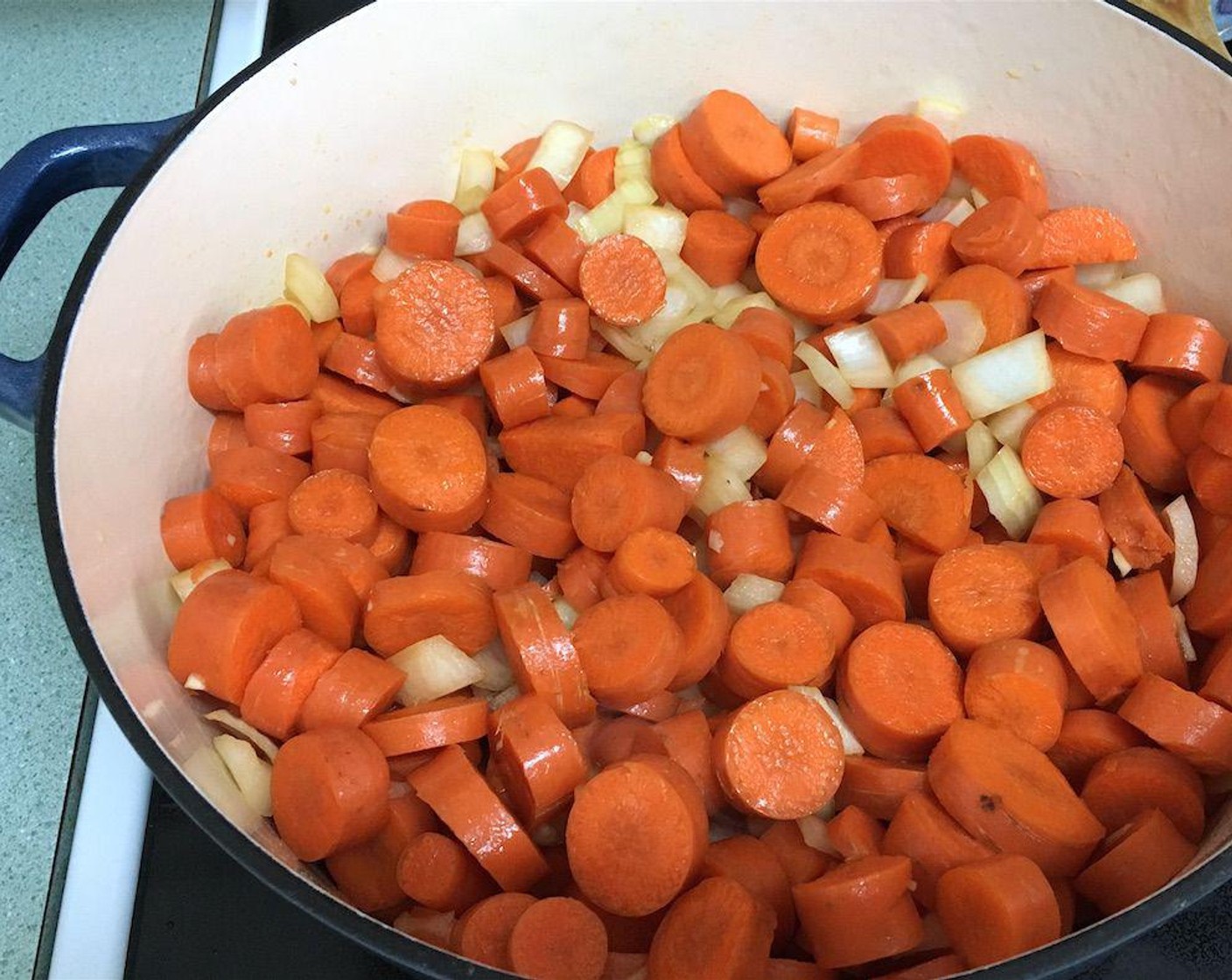step 4 Heat Extra-Virgin Olive Oil (3 Tbsp) in a large Dutch oven or stock pot over medium heat. Add chopped carrots, onion, and garlic. Stir and cook for about 5 minutes.