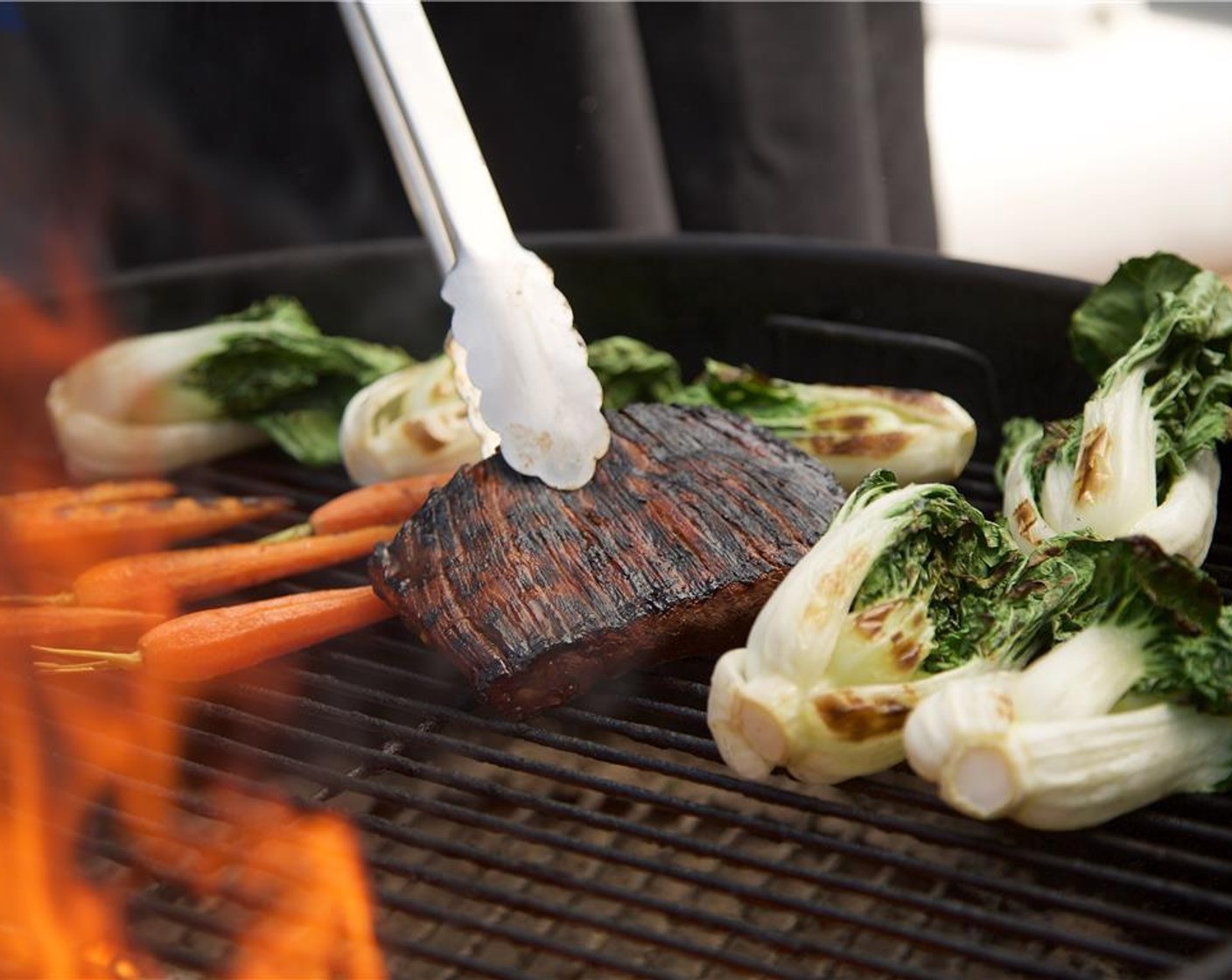 step 13 Place the French Baby Carrots (6) on the grill perpendicularly to the grill grates so that they don’t fall through. Cook the carrots for six minutes, periodically rotating to ensure even cooking. Move to cooler section of the grill to keep warm.