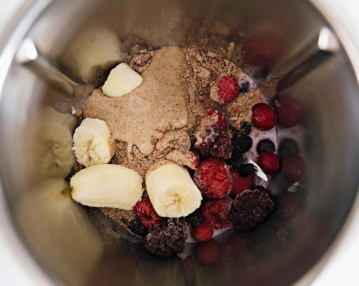 step 2 Peel and roughly chop the Banana (1). Add to your blender, along with the Frozen Mixed Berries (1 cup), juice from Lemon (1), Purely Pinole® Blueberry and Banana Power Breakfast (1/4 cup), Almond Butter (1 Tbsp), and Almond Milk (1/2 cup).