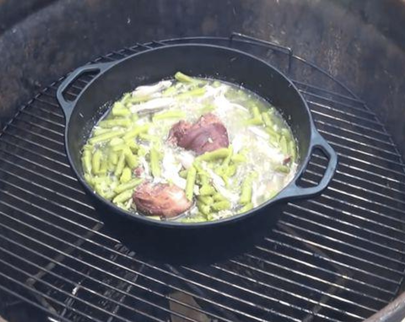 step 2 Then I add Onion (1), Garlic (2 cloves), Pulled Pork (1 cup), Salt (to taste), and Ground Black Pepper (to taste). Then add Ham Hock (2) and cover it all with Chicken Broth (4 cups). You can omit or replace any of these ingredients to your liking for your smoked green beans.