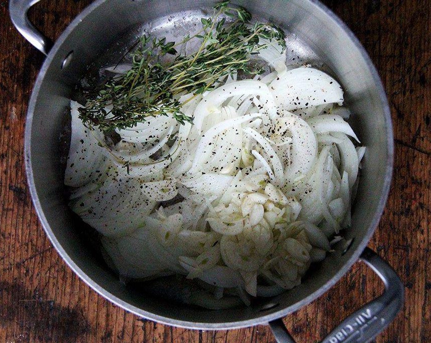 step 1 Melt Unsalted Butter (2 Tbsp) in a large heavy pot over medium heat. Add Fresh Thyme (2 sprigs), Onion (1), and Garlic (2 cloves). Season with Kosher Salt (to taste) and Freshly Ground Black Pepper (to taste). Cook until onion is completely soft and translucent, 10-12 minutes.