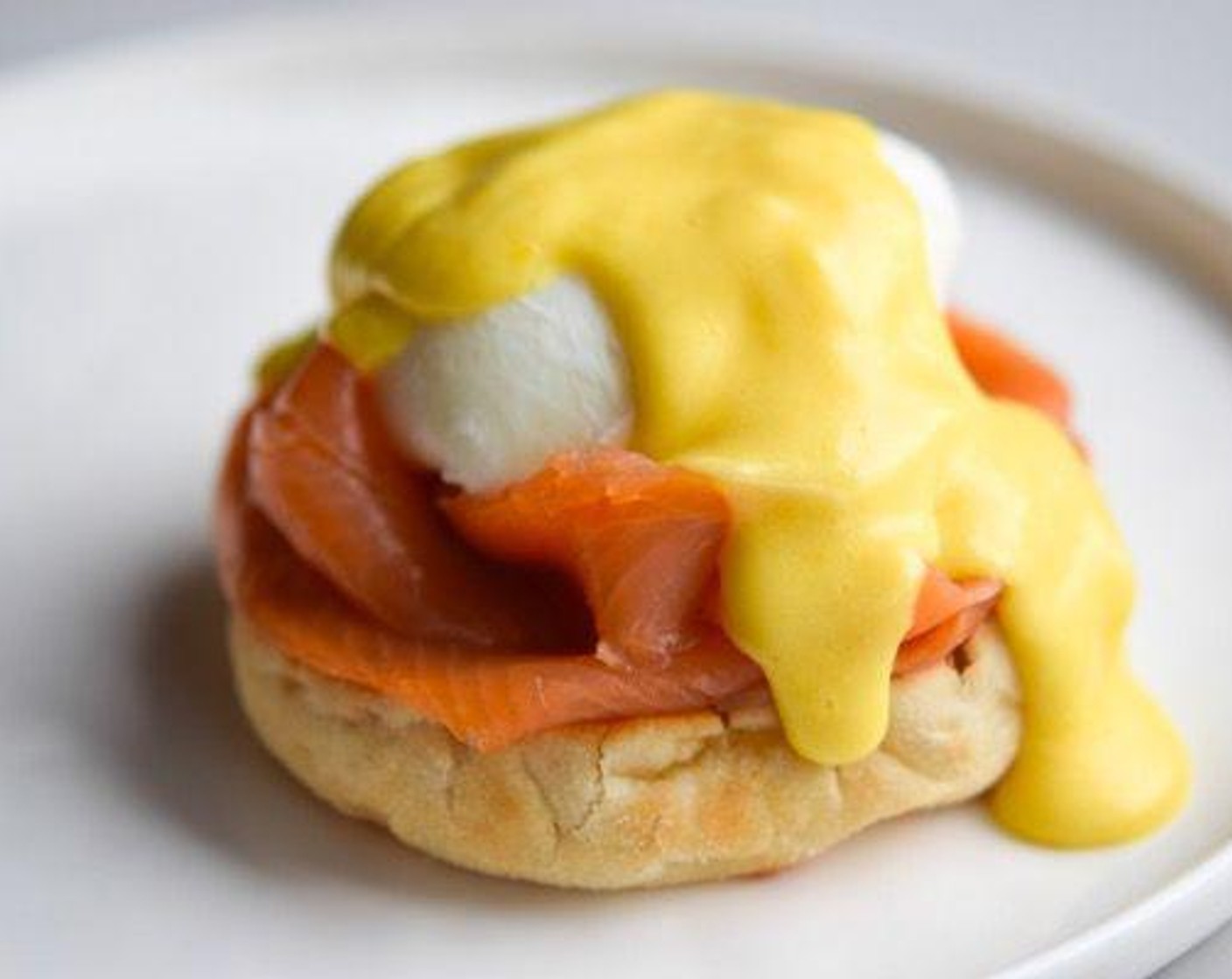 step 6 Butter each English Muffins (2) and top with a swirl of Smoked Salmon Trout (3.5 oz), making a small well in the middle for the poached egg to rest in. Slide the egg into the well and top with a generous dollop of that flawless Hollandaise and sprinkling of Fresh Chives (1 Tbsp). Serve and enjoy!