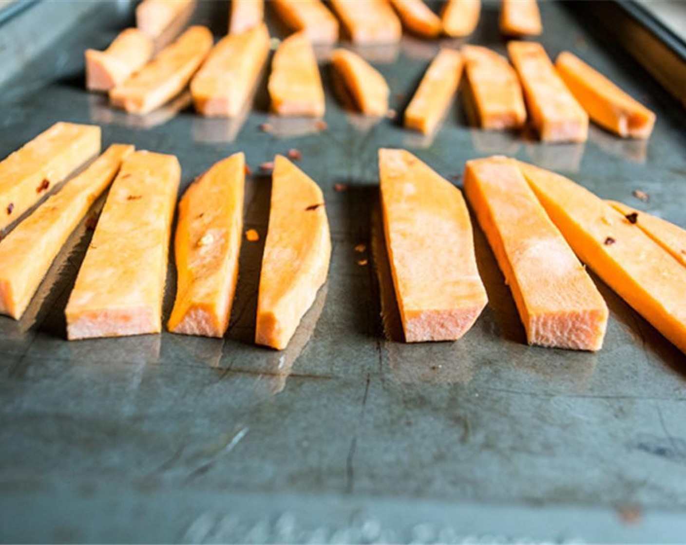 step 3 While quinoa cooks, cut the Sweet Potato (1) into small wedges, drizzle with Sesame Oil (1 tsp), toss to coat, then sprinkle with Crushed Red Pepper Flakes (to taste). Bake for 10 minutes.