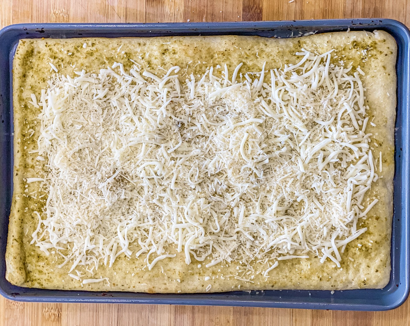step 6 Evenly spread ¼ of cheese blend over pizza crust.