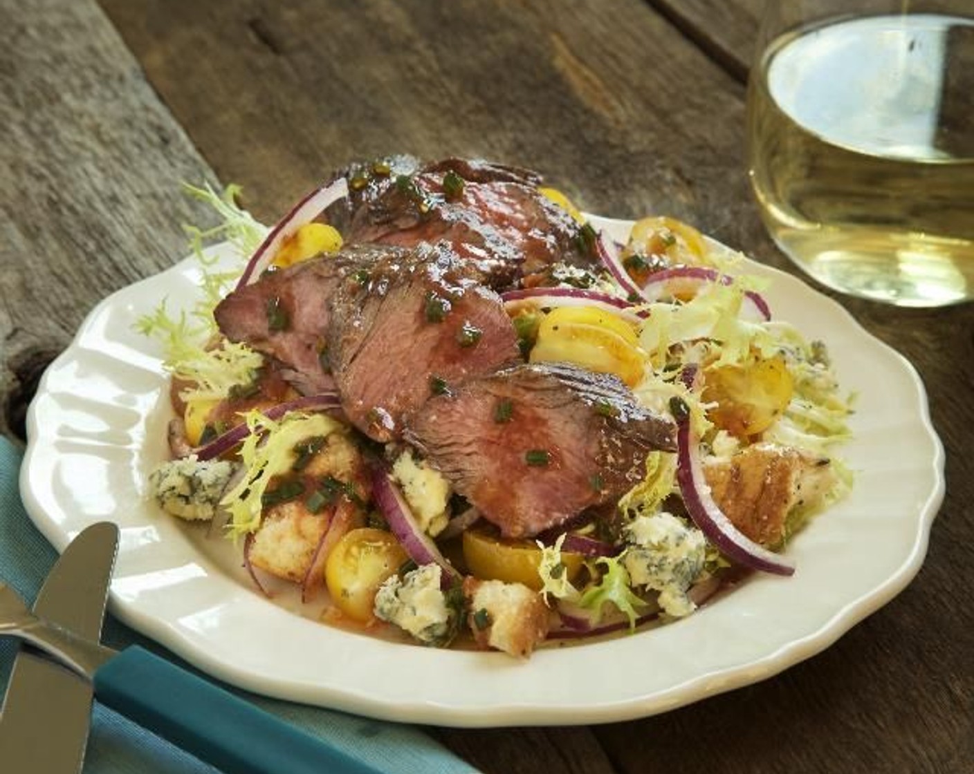 step 16 Fan the thinly sliced steak around the edge of the salad. Garnish each plate with only half the Blue Cheese (1/2 cup). Serve and enjoy!