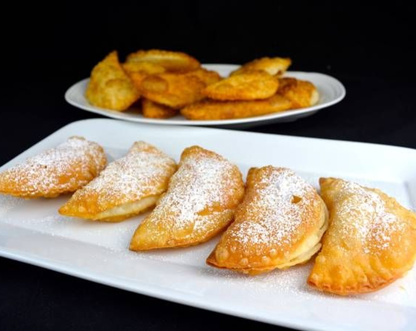 step 6 As they are done, remove and place on a plate with paper towels to absorb the excess oil. Garnish with Powdered Confectioners Sugar (to taste) right before serving.