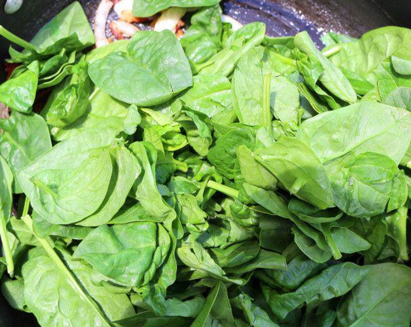step 6 Saute Bacon (2 oz), Garlic Paste (1 tsp), Onion (1/2), and Spinach Leaves (5 2/3 cups) in Butter (1/4 cup).