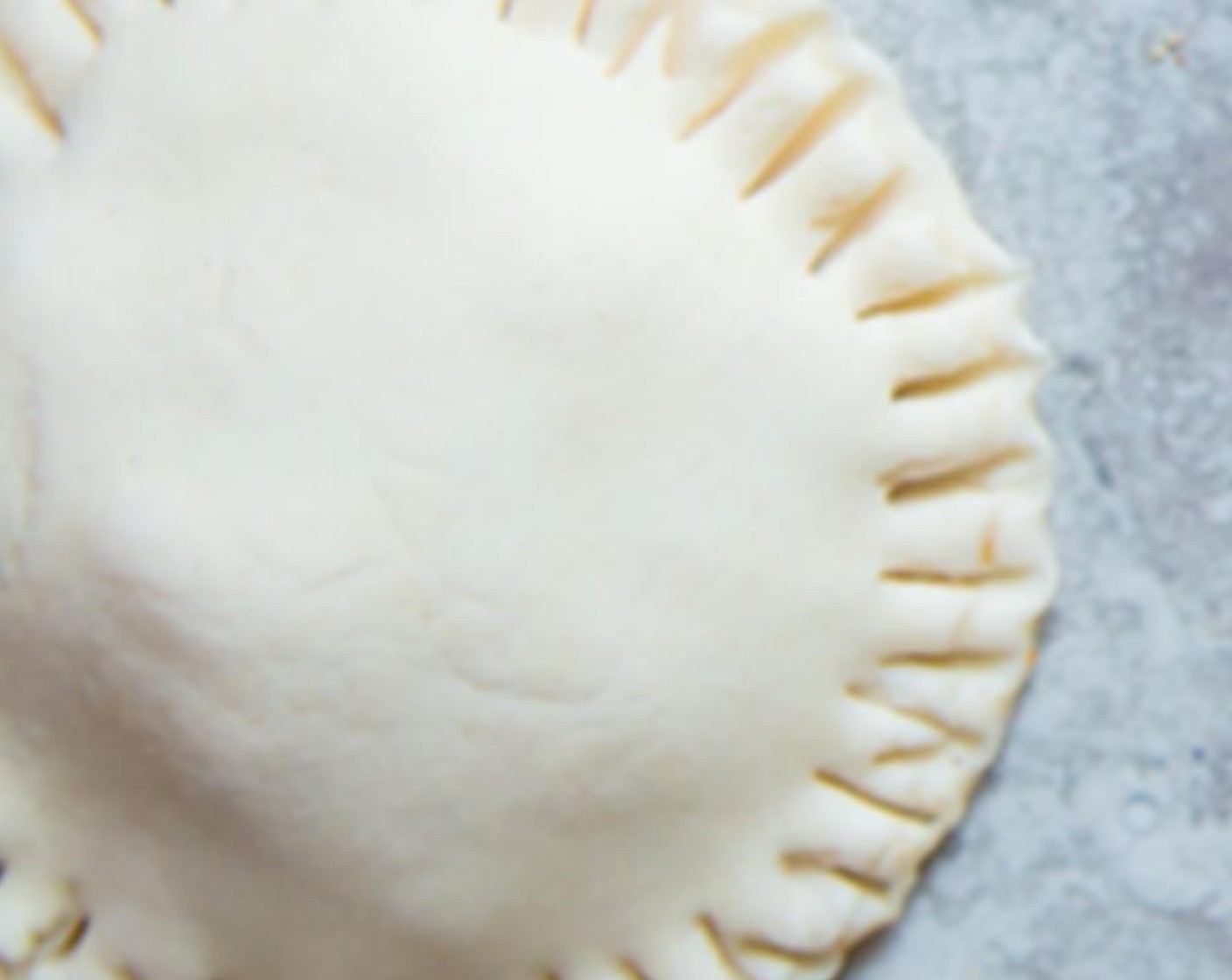 step 8 Dip your fingers in water and brush around the edges of the dough. This will help to seal the dough. Gently place a second dough circle on top of the first one and seal the edges with a fork. Repeat the same process until you have exhausted all the pastry dough.