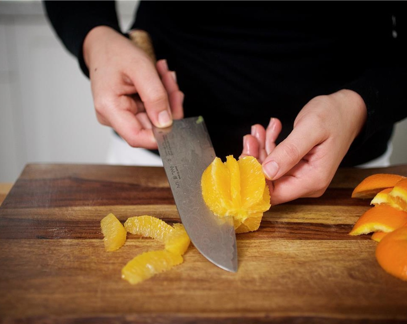 step 10 Zest the Orange (1) into a medium bowl. Remove the top and bottom of the orange, and discard. Using even downward strokes, slice the skin away from the flesh and discard. Over the bowl with the zest, cut between membranes to segment the orange.