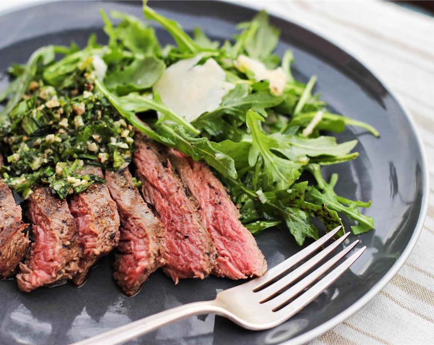 step 8 Whe the steak is done resting, slice against the grain into half-inch pieces. Serve with gremolata and arugula salad. Enjoy!
