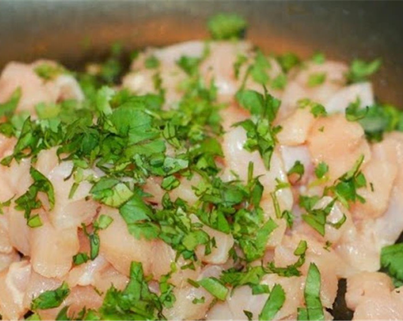 step 4 Add additional Vegetable Oil (2 tsp), diced chicken, and cilantro to the pan, sprinkle with the Goya® Sazon con Culantro y Achiote (1 pckg) and cook thoroughly, 6-8 minutes. Remove from pan, drain, and place in a medium bowl.