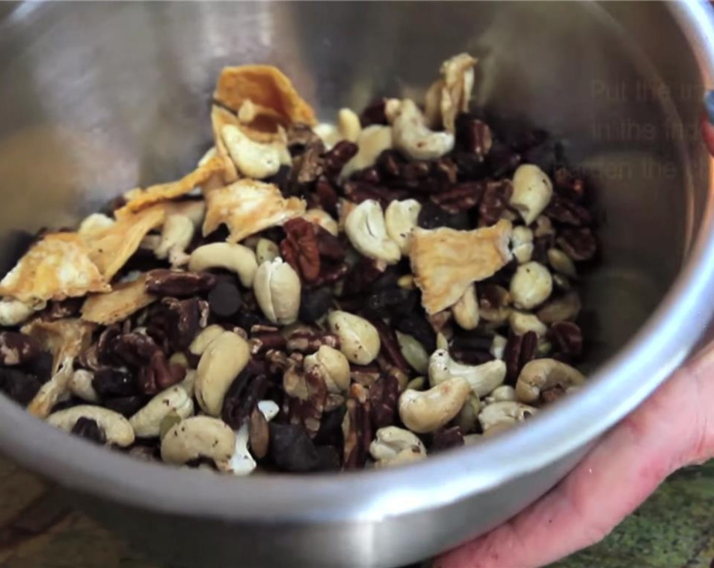 step 3 When done, put hot Pecans and Pumpkin Seeds from cookie sheet into the bowl with other ingredients and mix up well to spread chocolate throughout the mix.