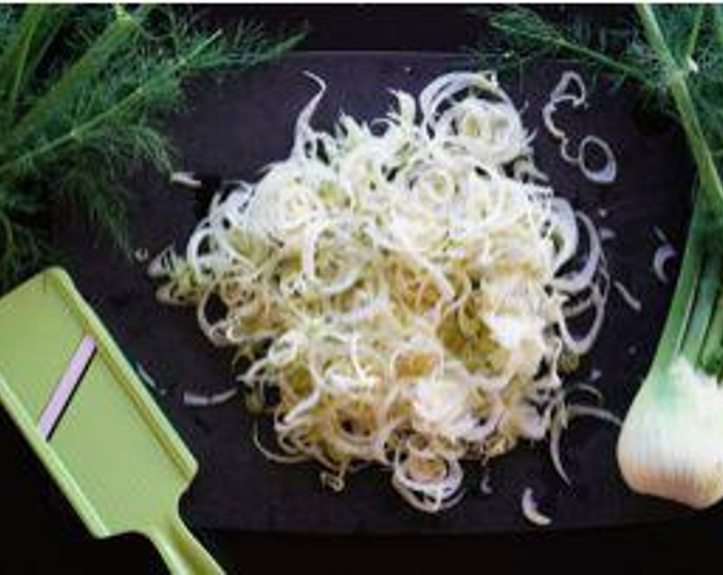 step 1 Slice the Fennel Bulbs (2) on a mandolin. Add to a large bowl.