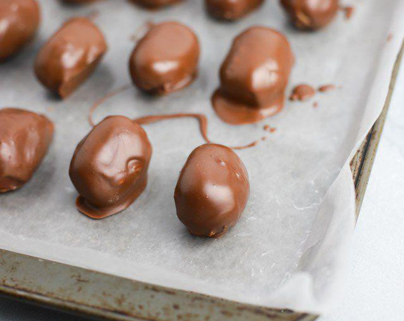 step 6 Remove eggs from the freezer. Drop each egg into the melted chocolate and toss between two forks until coated. Place eggs back onto baking sheet once coated. Refrigerate eggs until ready to serve. If you don't like to eat them cold, just let sit out for 30-60 minutes so they return to room temperature. Enjoy!