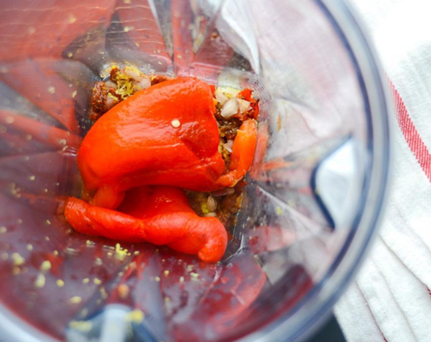 step 6 Peel the skin and remove the seeds from the bell pepper. Add the bell pepper flesh to a blender. Add the spices, the onion mixture, Crushed Red Pepper Flakes (1/8 tsp), Tomato Paste (1/2 Tbsp), Kosher Salt (1 tsp) and the zest and juice from the Lemon (1).