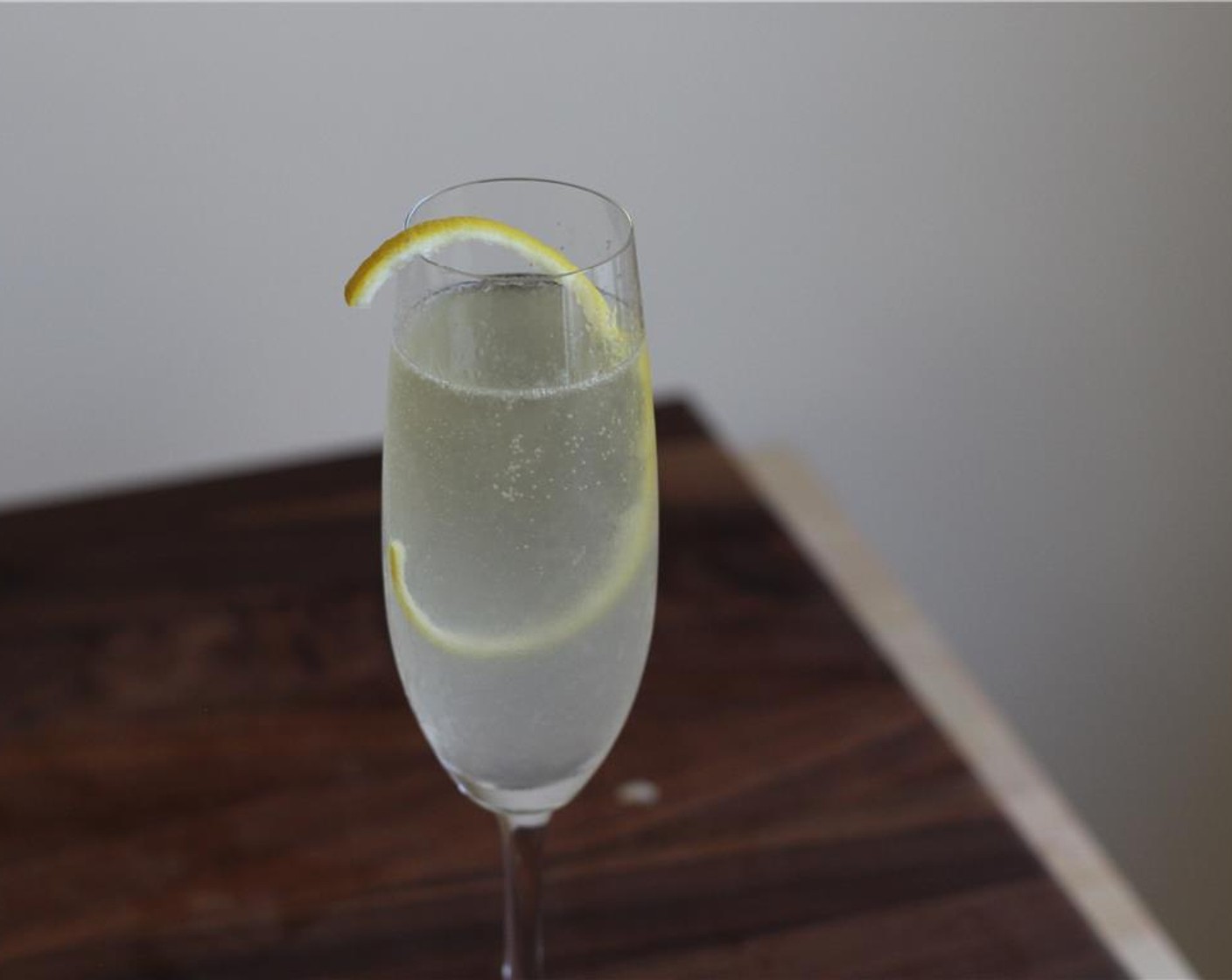 step 4 Top with Champagne (to taste) and garnish with lemon peel.