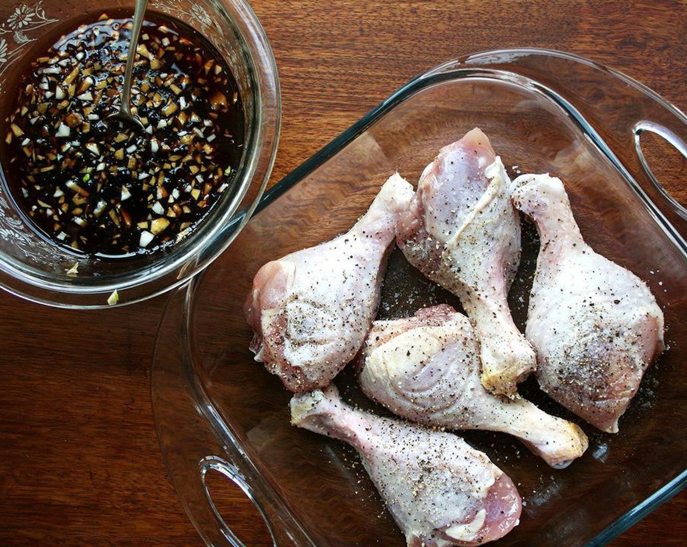 step 2 Wash and dry the Chicken Drumsticks (12 pieces). If using wings, cut off the wingtips. Transfer chicken to a rimmed baking sheet, a 9x13-inch pan, or an 8-inch square pan, depending on how much chicken you are using. Season lightly with Kosher Salt (to taste) and Freshly Ground Black Pepper (to taste).
