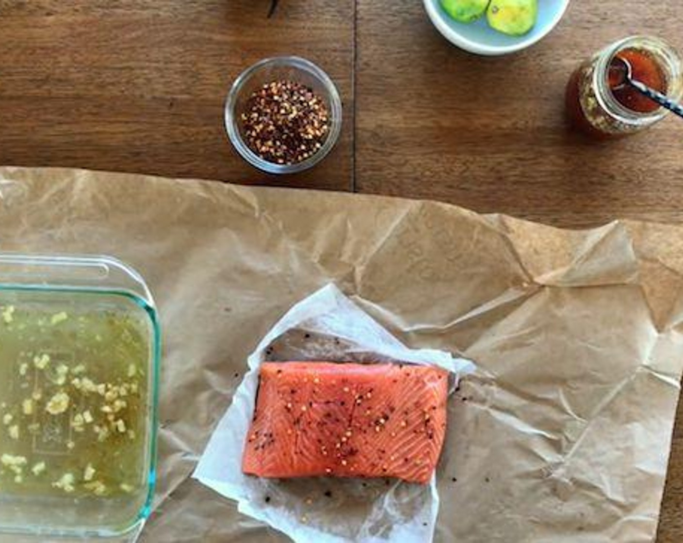 step 3 Season the Wild Salmon Fillets (1.5 lb), Crushed Red Pepper Flakes (to taste), Salt (to taste), and Ground Black Pepper (to taste). Place the salmon SKIN SIDE UP. This is the big trick in the recipe. It allows all the fat to seep into the salmon as it cooks. Also makes for easy skin removal.