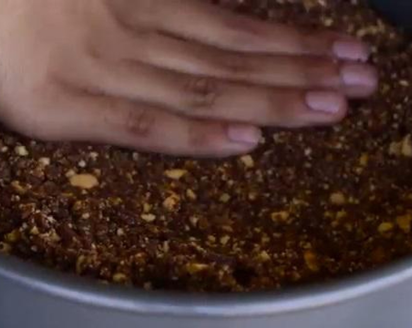 step 4 Place your mixture into a cake pan, and press the surface gently so that it will be compressed and evened out. Put the pan into the fridge and proceed to make the filling.