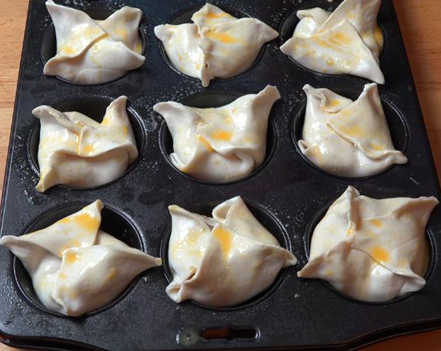 step 4 Lightly brush the top of each pie with Eggland's Best Classic Egg (1).