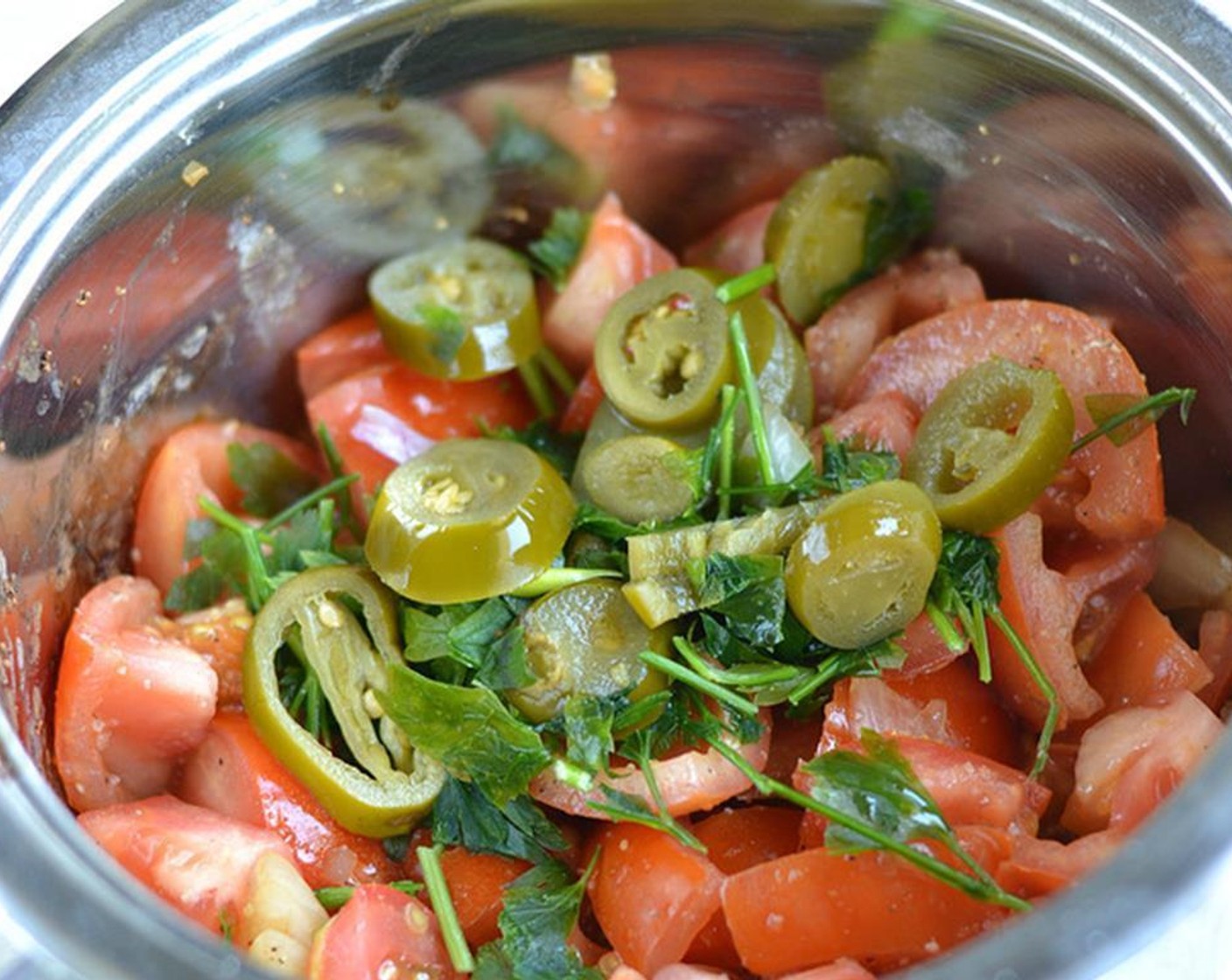 step 3 Add the tomato and let it cook for another minute. Add Jalapeño Pepper Slices (to taste) and the cilantro.