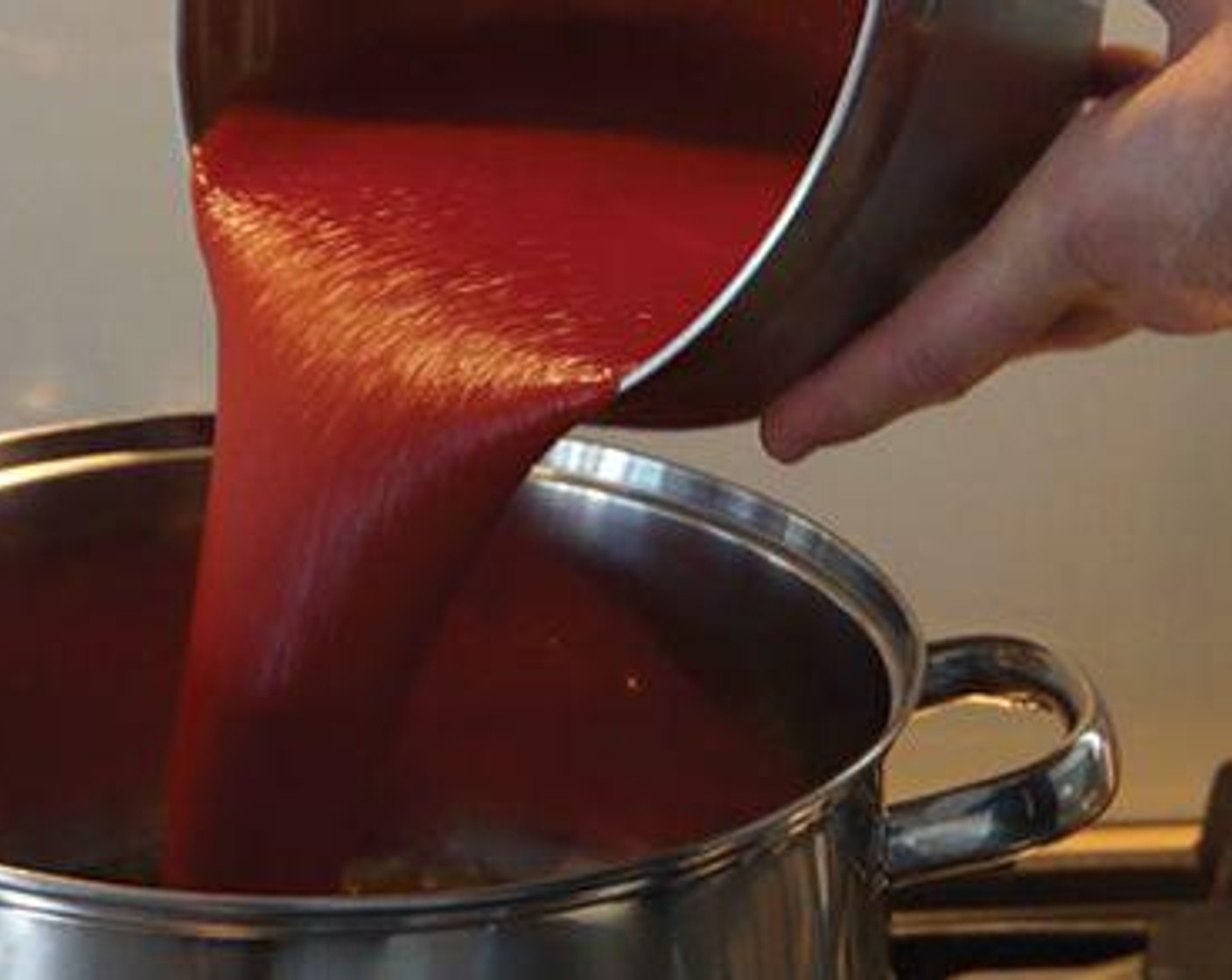 step 2 Add the Tomato Passata (2 bottles) and stir it in with the caramelised ​​onions.