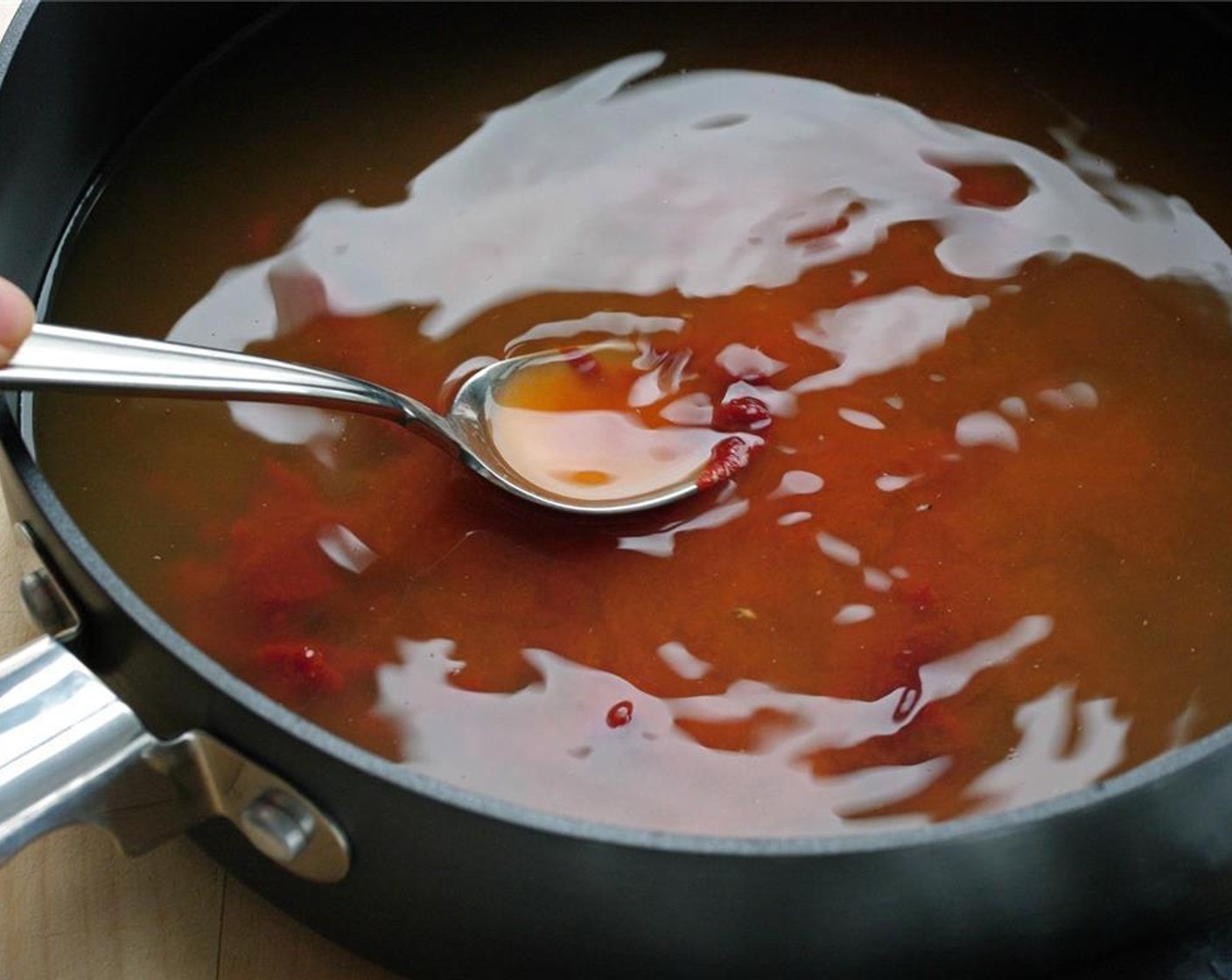 step 11 Smear the paste with spoon to mix in with the stock.