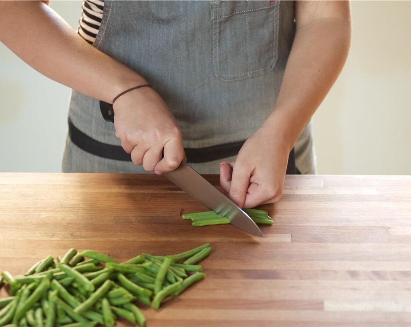 step 2 Slice two of the Scallion (1 bunch) into quarter inch thin slices. Slice the remaining green onions into three inch pieces. Set aside. Trim ends off of Green Beans (1 1/2 cups) then slice in half on a diagonal.