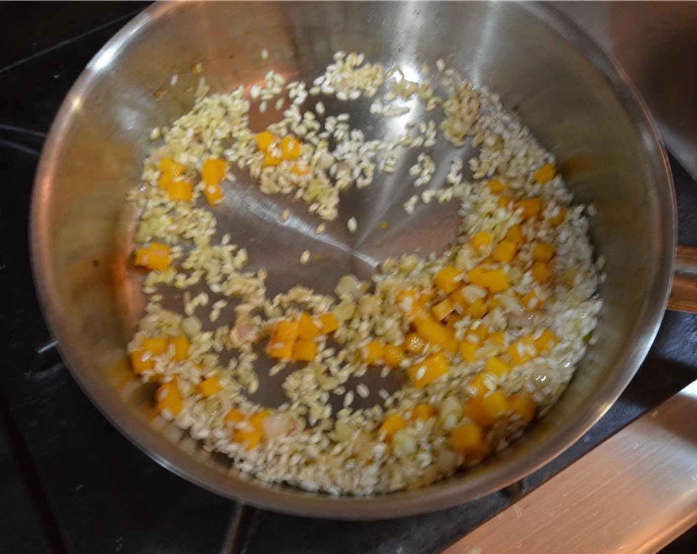 step 5 Add the Carnaroli Rice (1 cup), Pumpkin (1 cup), and coat in the sweated shallots and oil mixture for two minutes.