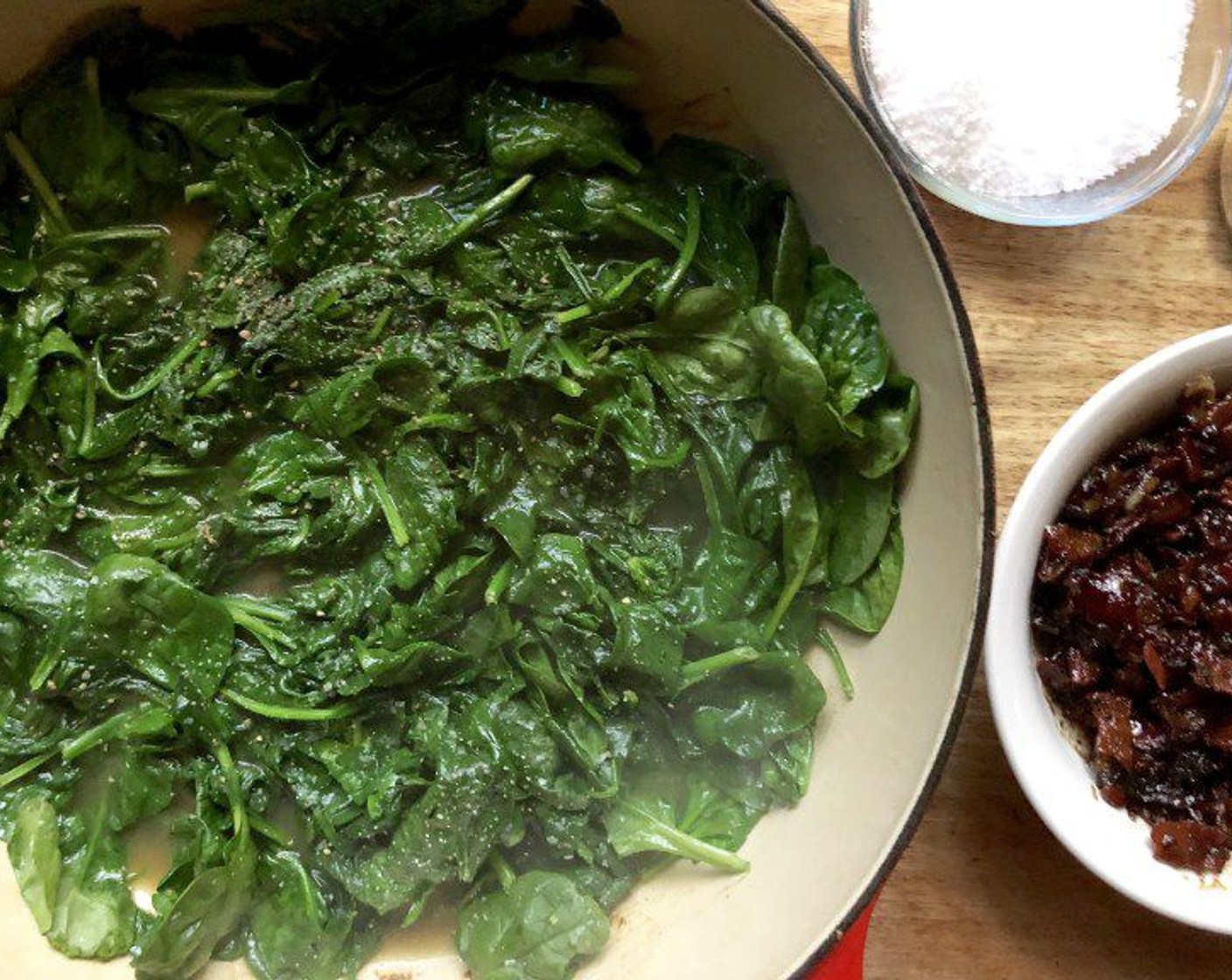 step 12 Meanwhile, pour off all but 1 tablespoon of the oil from the skillet. Place the skillet over high heat. Add the Fresh Baby Spinach (15 cups) and cook just until it is barely wilted, about 20 seconds. Season to taste with Sea Salt (to taste) and Freshly Ground Black Pepper (to taste). Immediately remove the spinach from the pan to halt the cooking and place it on a serving platter.