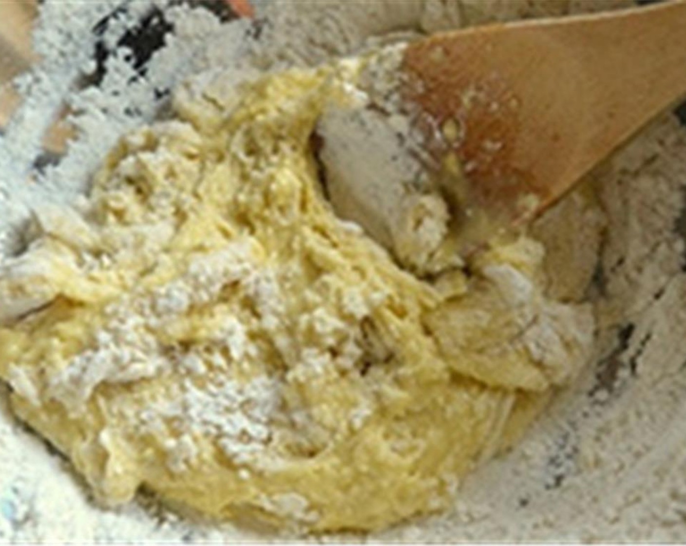 step 2 Gradually start mixing the wet and dry ingredients with a wooden spoon making sure the well stays intact. Just keep stirring in a circular motion, incorporating more and more flour into the egg until you get a soft, shaggy ball of dough.