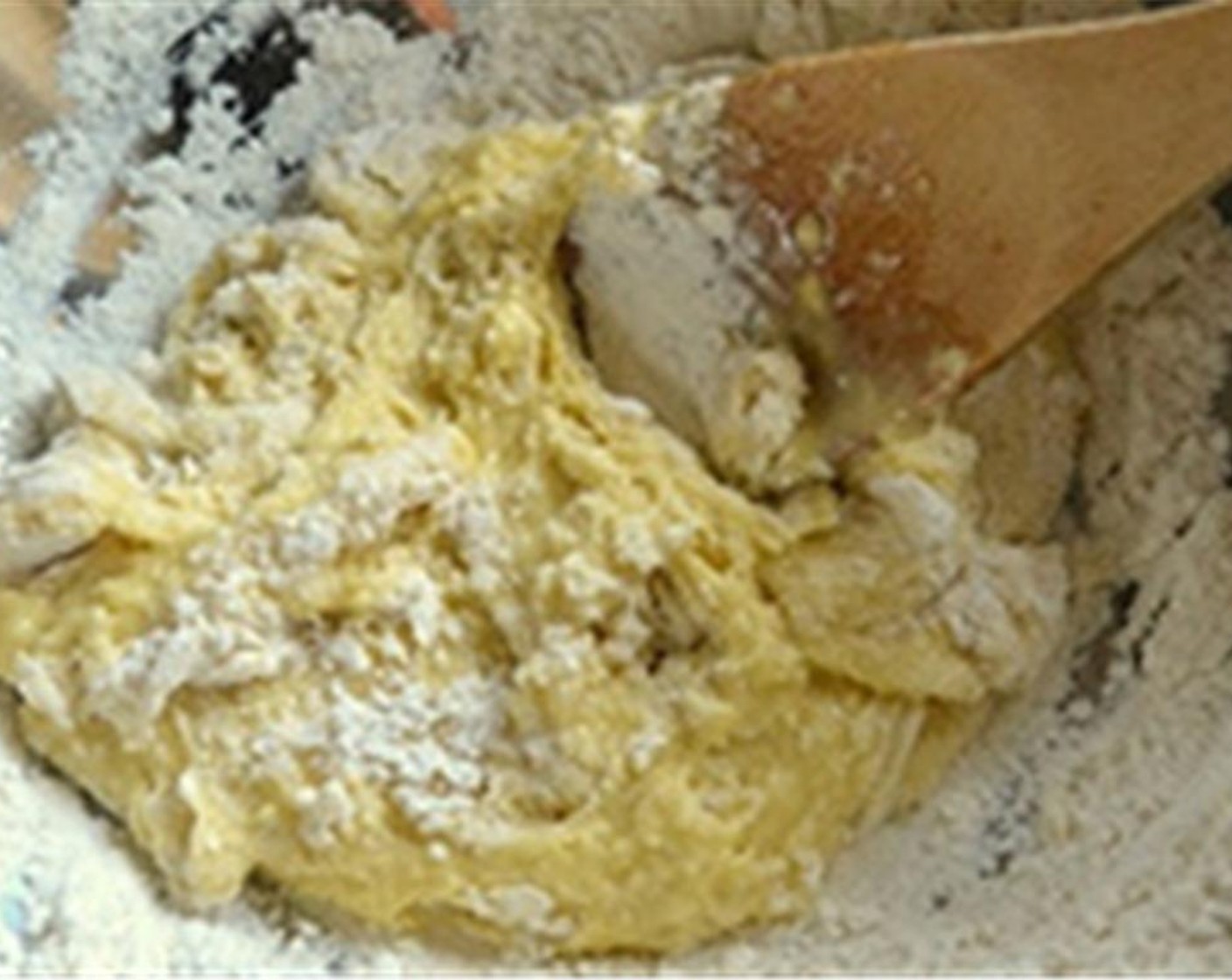 step 2 Gradually start mixing the wet and dry ingredients with a wooden spoon making sure the well stays intact. Just keep stirring in a circular motion, incorporating more and more flour into the egg until you get a soft, shaggy ball of dough.