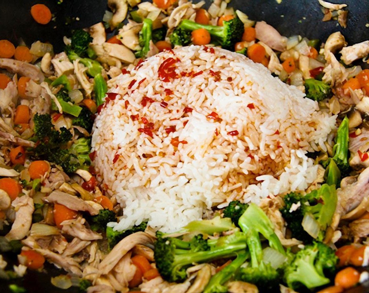 step 10 Make a well in the center of the wok or pan and add the cold rice, along with any remaining sauce.