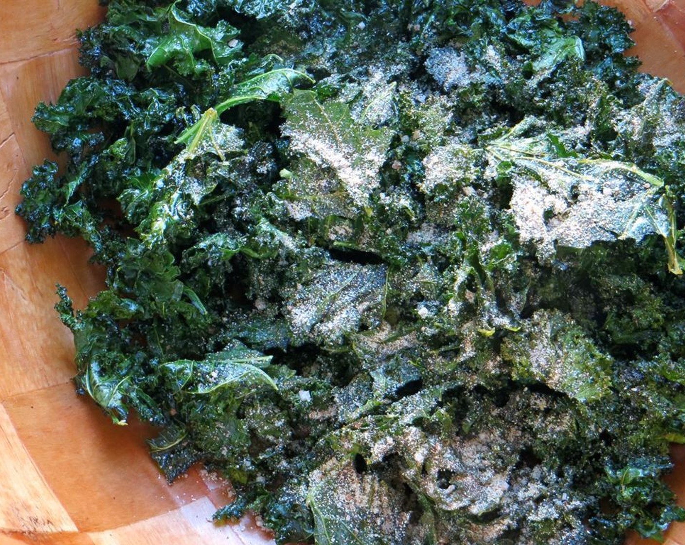step 6 Sprinkle the seasoning over the kale chips. Toss gently with your hands to coat the chips.