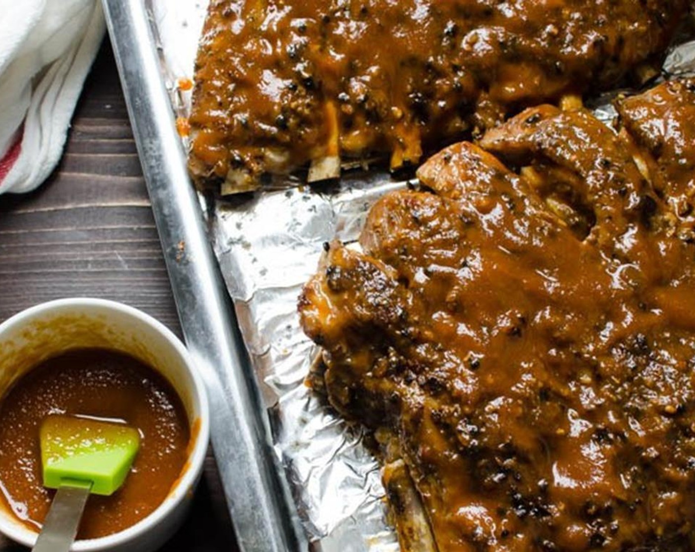 step 10 Remove the tin foil from the top of the ribs and liberally brush them with the barbecue sauce, flip them and coat the other side with sauce. Return the ribs to the oven, uncovered and broil until they are well glazed and take on a little color, about 5-10 minutes.