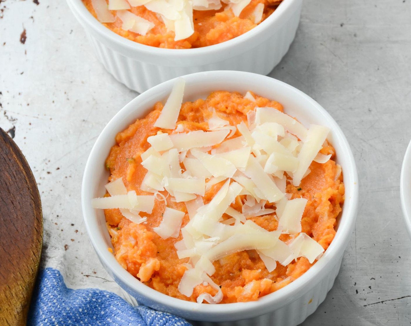 step 8 Spray 4 half-cup ramekins with vegetable spray. Divide the sweet potatoes among the ramekins and smooth the tops with the back of a spoon. Sprinkle with the remaining Gruyère Cheese (4 Tbsp).