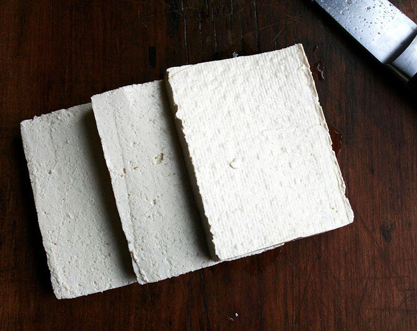 step 5 Carefully cut the drained tofu into three slices. Working with one piece at a time, submerge the tofu into the egg, then coat it in the sesame-panko mix, then place it on a clean plate. Repeat with the remaining two slices.