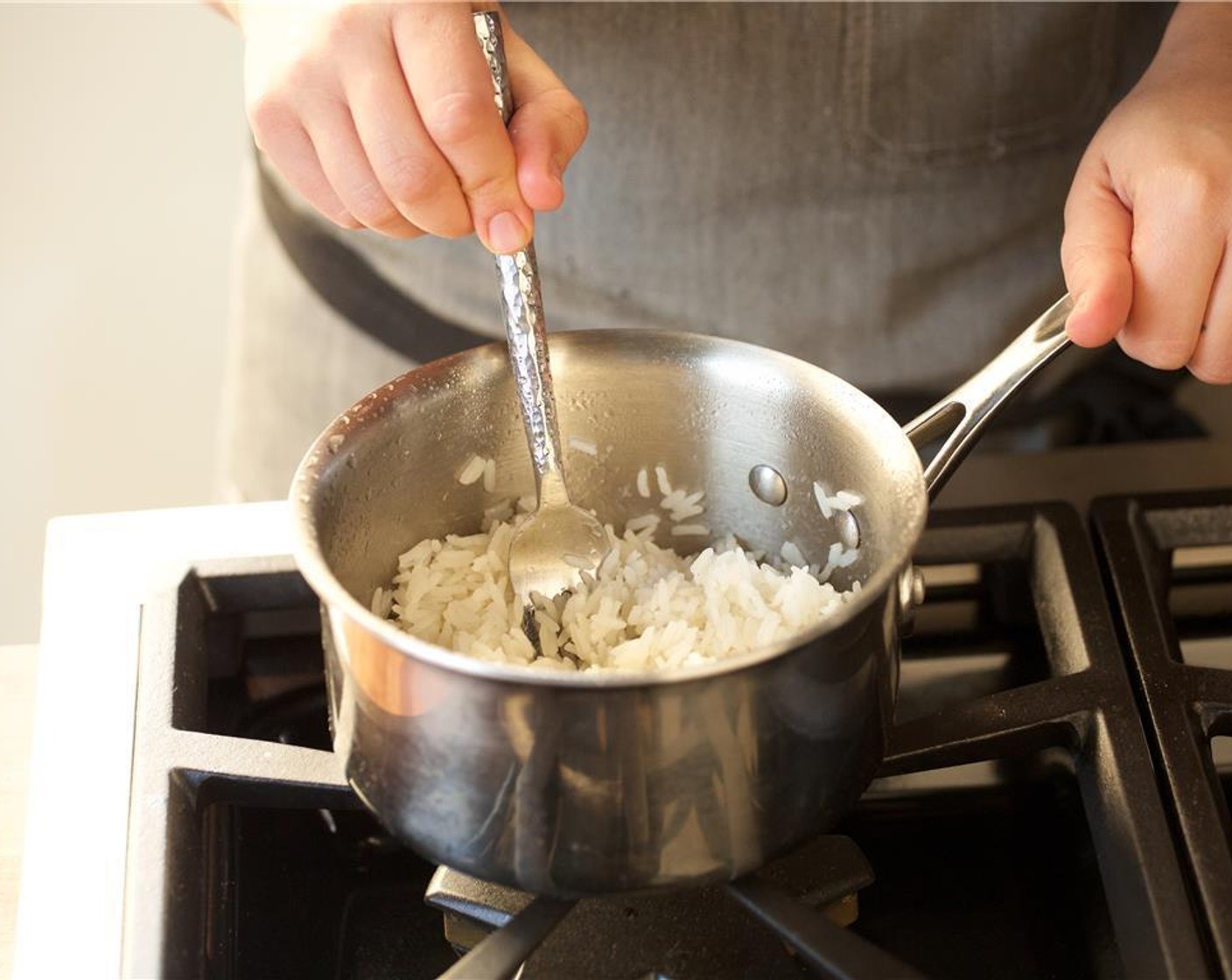 step 4 In a small saucepan, add one cup of water and the jasmine rice and bring to a boil over medium high heat. Stir once, then cover and reduce heat to low. Simmer for ten minutes. Remove from heat, fluff, and hold.