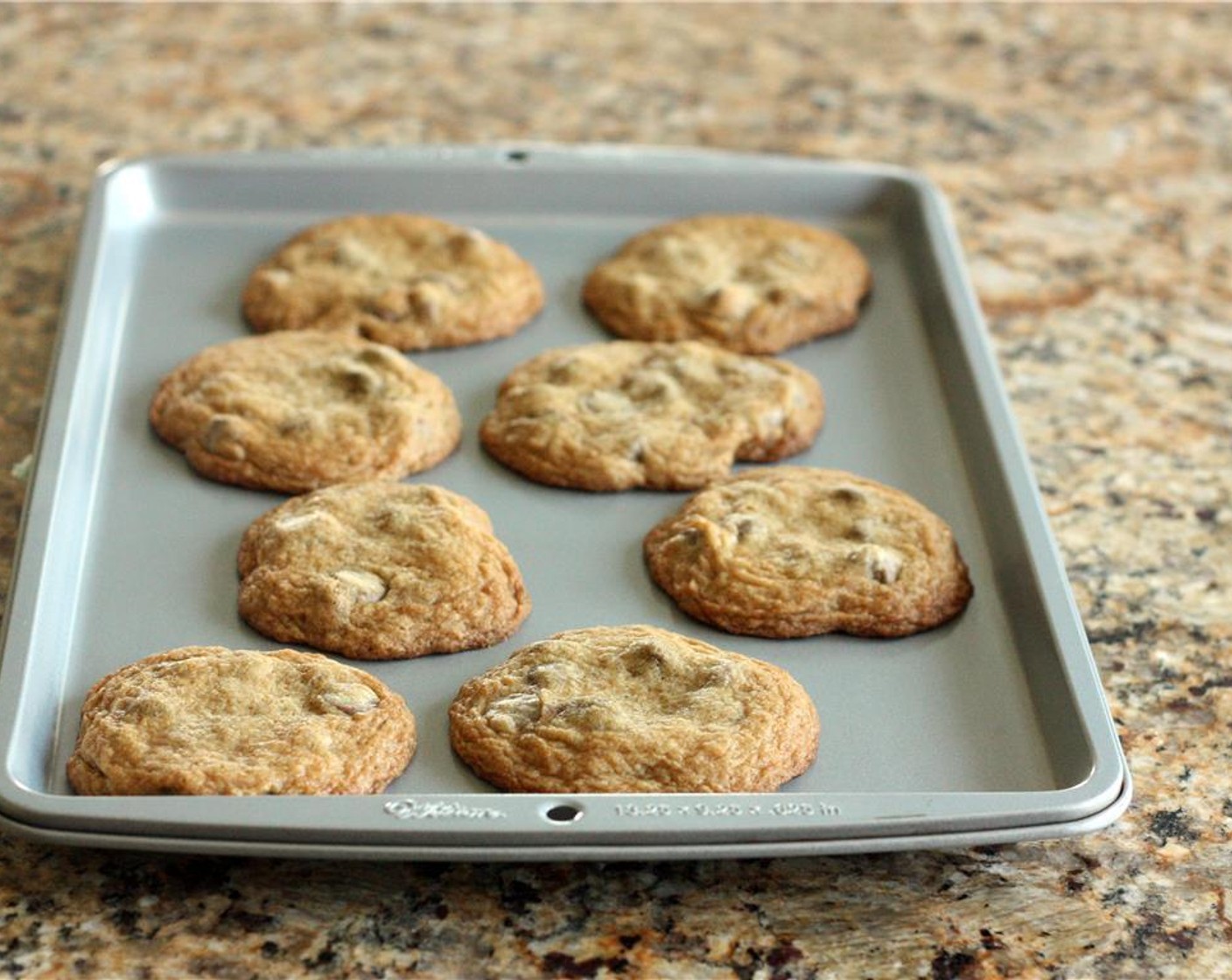 step 6 Remove cookie sheet from the oven and let the cookies sit for 1-2 minutes, then lift the cookies onto a serving tray with a spatula.
