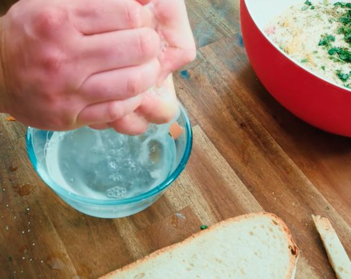 step 8 Now dip the Bread (2 slices) into the bowl filled with Water (to taste), a couple at a time, then quickly removing them and squeezing all the water out using your hands.